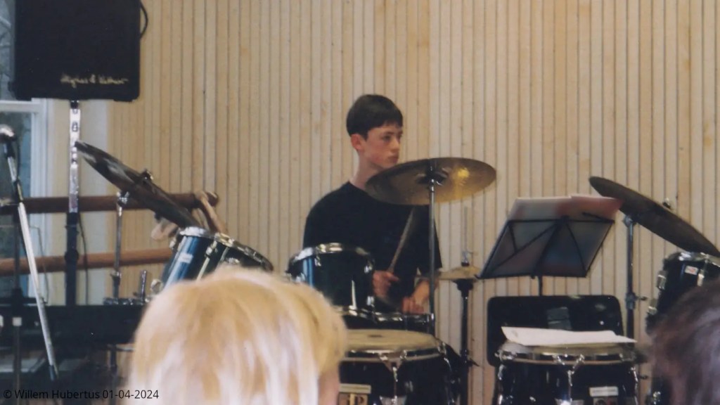 Performing drums live in front of an audience.