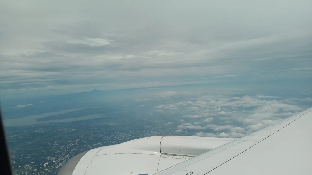 View from airplane window. Flying above Japan. Mount Fuji can be seen.