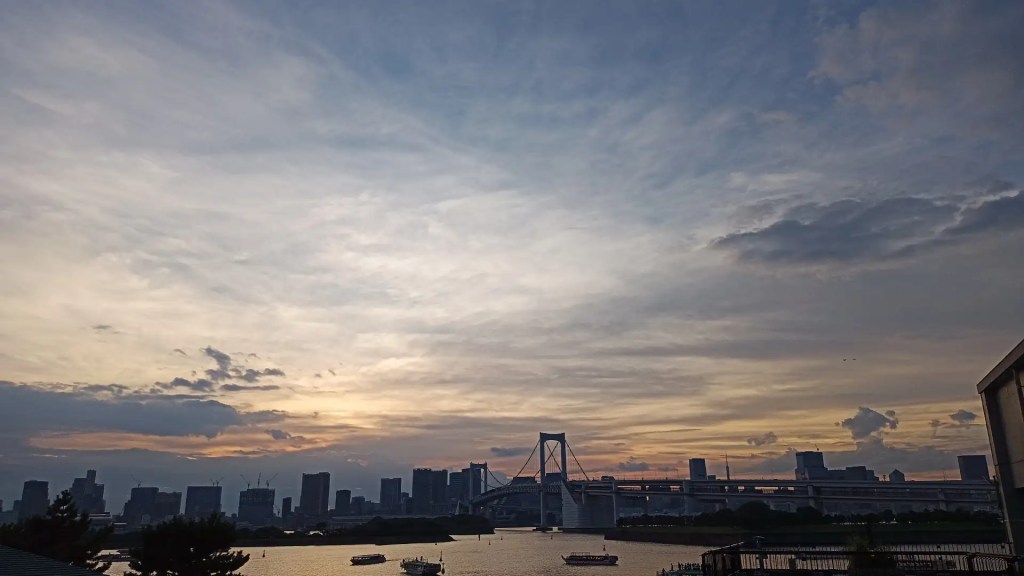 The Tokyo skyline as seen from Odaiba. The sun is setting. Beautiful colored sky.
