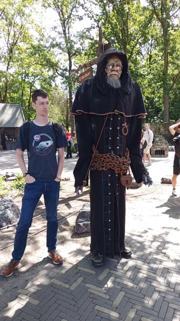 Standing next to a figure outside the Danse Macabre ride in the Efteling.