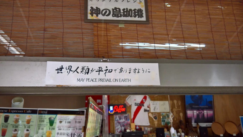 A sign from a coffeeshop that reads "May peace prevail on Earth".