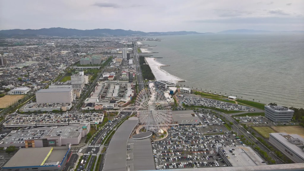 A room on the 45th floor. The hotel is on the shoreline, so the view on the left is the city, the right is the sea, with a ferris wheel in the front and a mountain chain in the back.